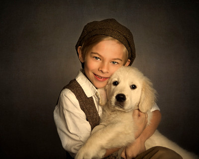 Boy in hat holding dog